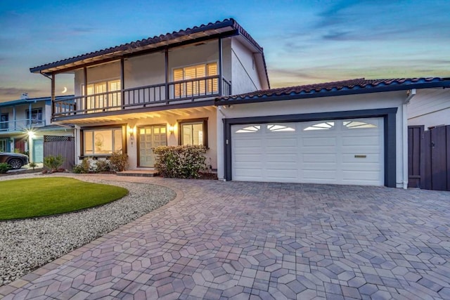 view of front of house featuring a garage and a balcony