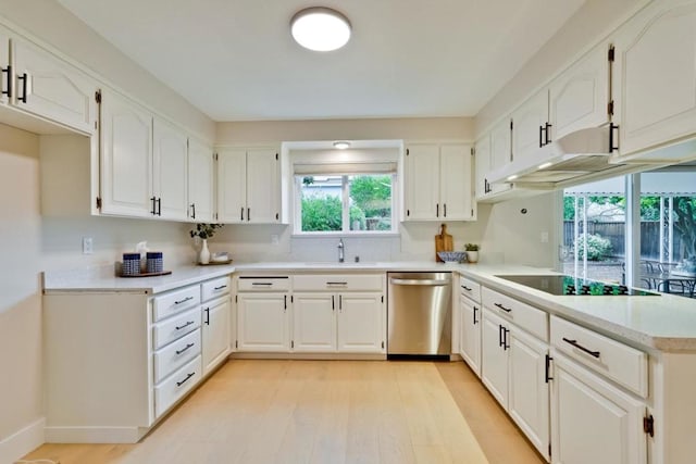 kitchen featuring sink, white cabinetry, dishwasher, kitchen peninsula, and black electric stovetop