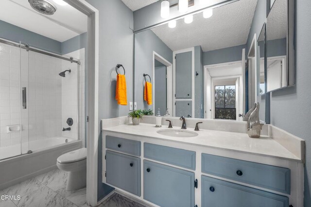 full bathroom featuring toilet, vanity, bath / shower combo with glass door, and a textured ceiling