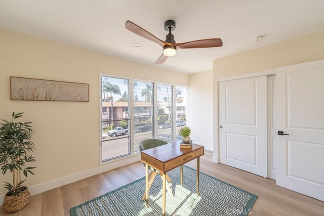 office with ceiling fan and light wood-type flooring