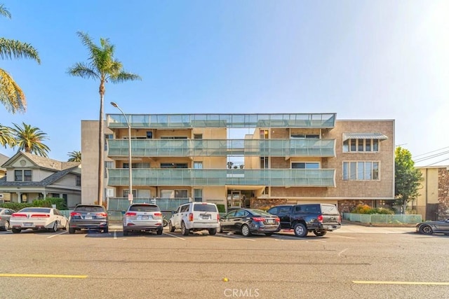 view of property featuring uncovered parking