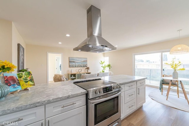 kitchen featuring white cabinetry, island range hood, light stone counters, and stainless steel electric range