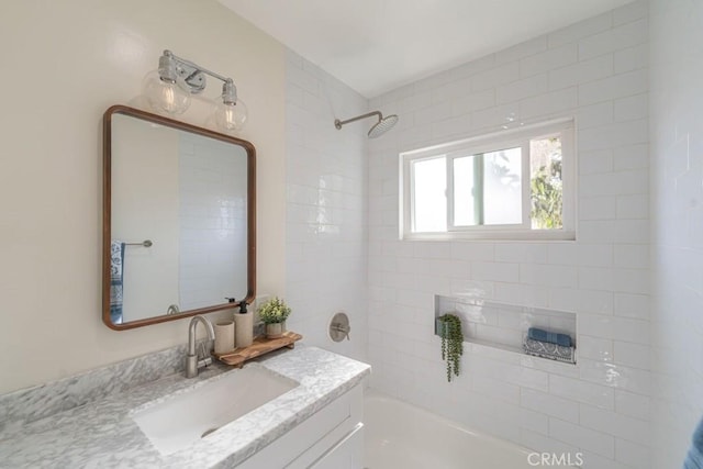 bathroom with vanity and tiled shower / bath combo