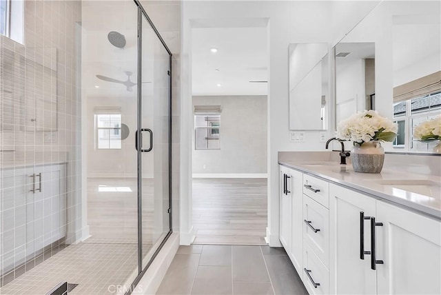 bathroom with tile patterned flooring, vanity, ceiling fan, and a shower with shower door