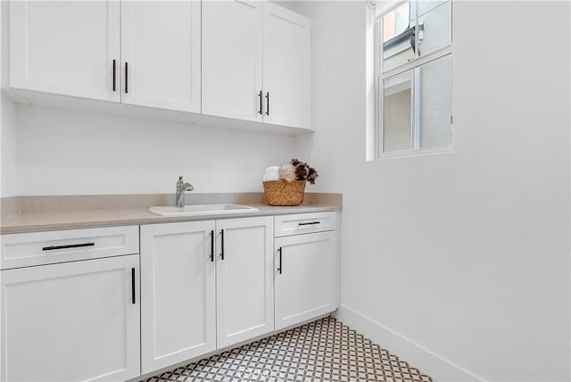 bar featuring sink and white cabinets