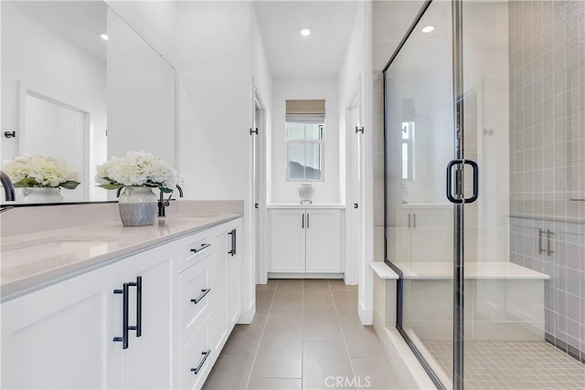 bathroom with walk in shower, tile patterned floors, and vanity