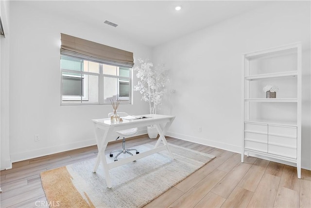 office with light hardwood / wood-style flooring