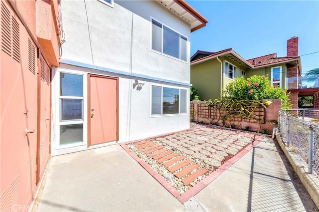 back of property with a patio