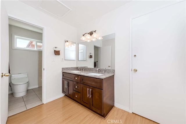 bathroom featuring hardwood / wood-style flooring, vanity, and toilet