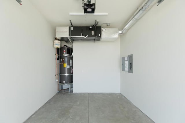 garage featuring water heater, a garage door opener, and electric panel