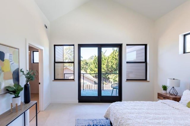 bedroom with light colored carpet, access to exterior, and high vaulted ceiling