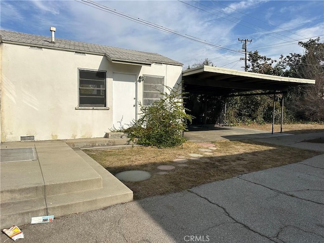 view of property exterior with a carport