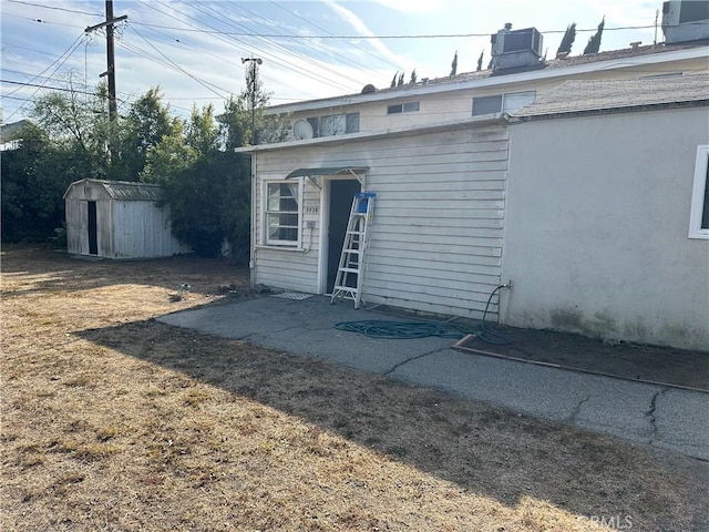 exterior space featuring cooling unit and a lawn