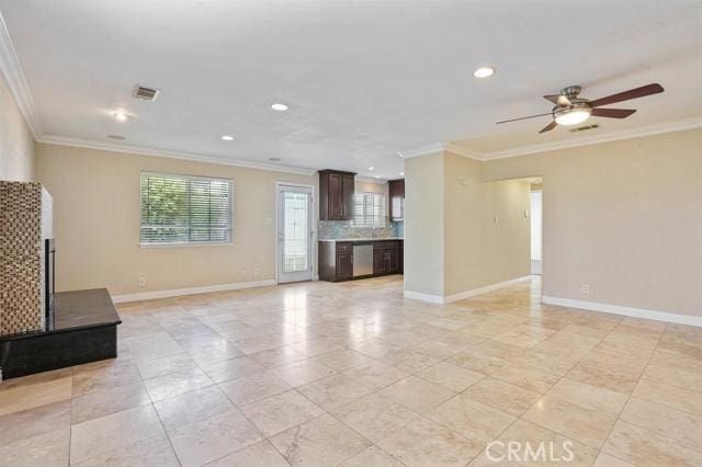 unfurnished living room with light tile patterned floors, crown molding, and ceiling fan