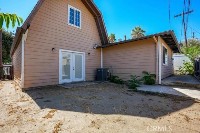 back of house with a patio, french doors, and central air condition unit