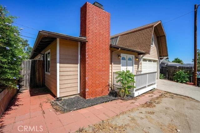 view of side of home with covered porch