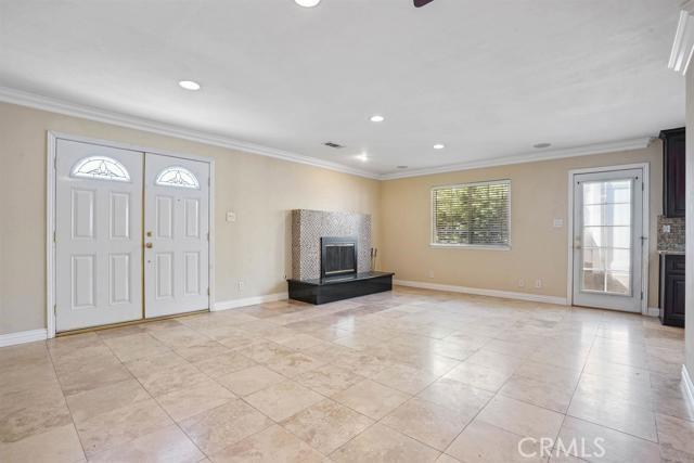 tiled entryway featuring ornamental molding