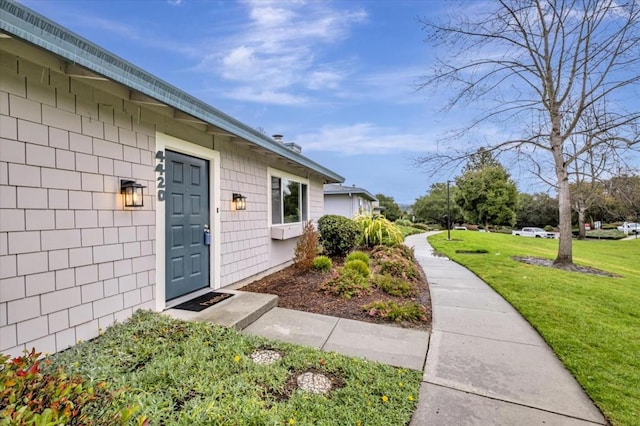 entrance to property with a yard