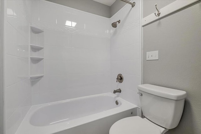 bathroom with tiled shower / bath combo and toilet