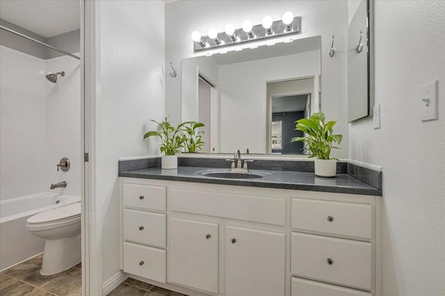 full bathroom with tiled shower / bath combo, vanity, and toilet