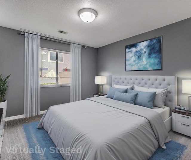 carpeted bedroom featuring a textured ceiling