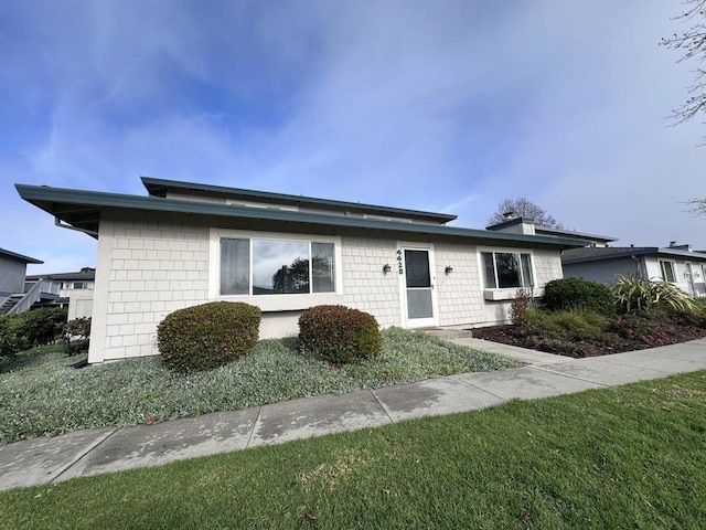 ranch-style house with a front lawn