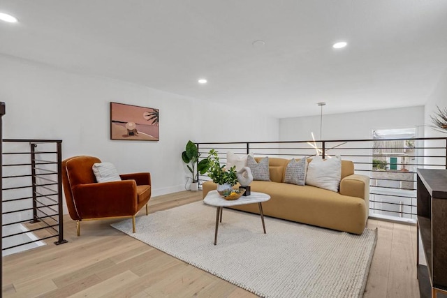 living room featuring an inviting chandelier and light wood-type flooring