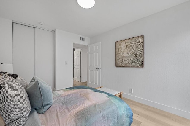 bedroom with a closet and light wood-type flooring