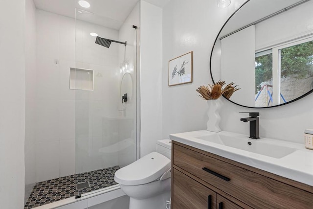 bathroom featuring vanity, an enclosed shower, and toilet