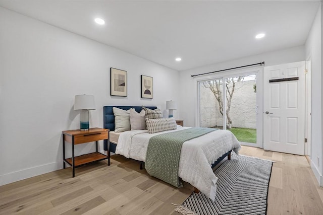 bedroom with access to exterior and light wood-type flooring