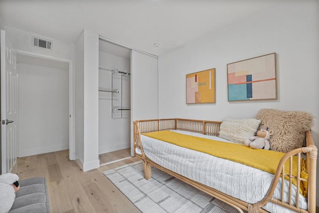 bedroom featuring light hardwood / wood-style floors and a closet