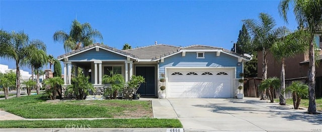 view of front of home featuring a garage and a front yard