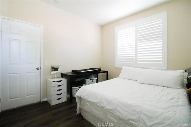 bedroom with dark hardwood / wood-style flooring