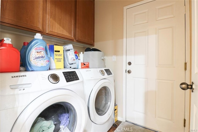 laundry room with cabinets and washing machine and clothes dryer