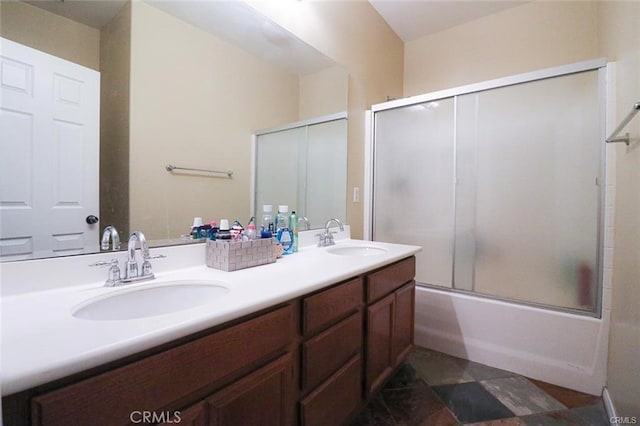 bathroom featuring enclosed tub / shower combo and vanity