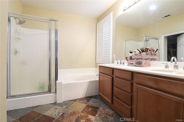 bathroom with vanity and separate shower and tub