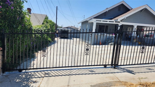 view of gate with a fenced front yard