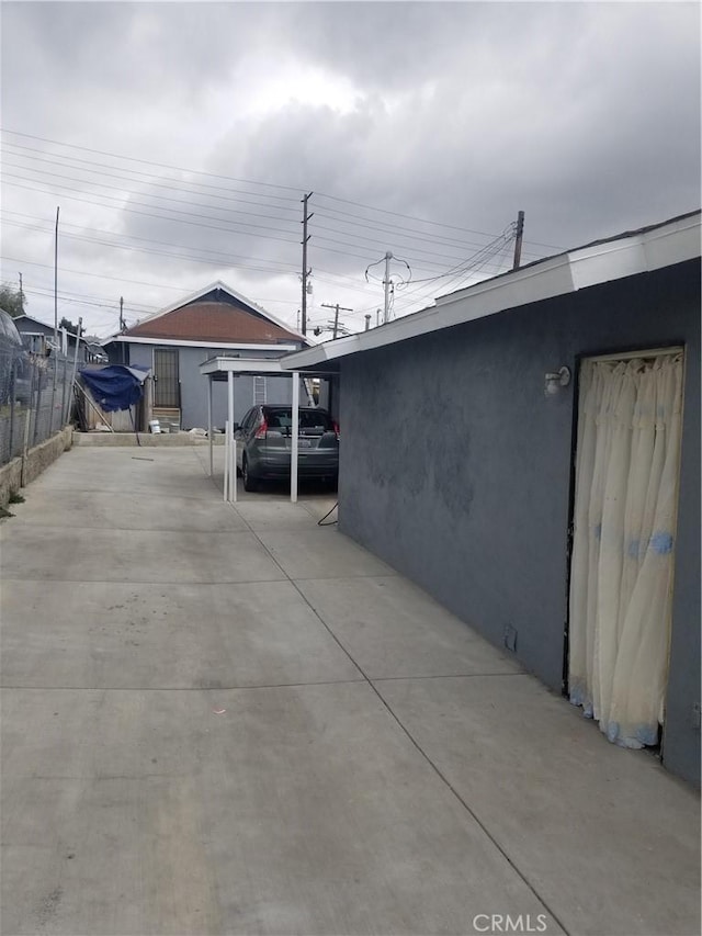 view of home's exterior featuring fence and stucco siding