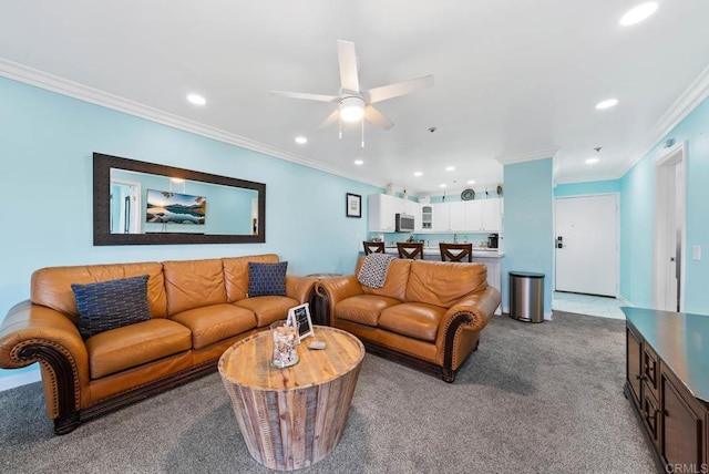 carpeted living room with crown molding and ceiling fan