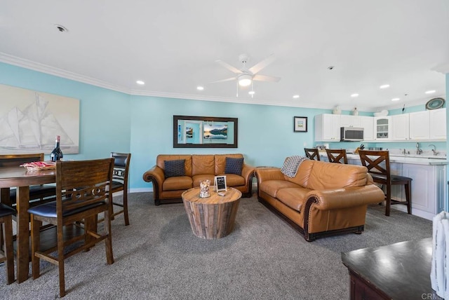 carpeted living room featuring ceiling fan and ornamental molding