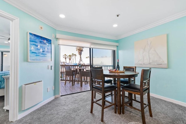 dining room featuring radiator, crown molding, and carpet flooring