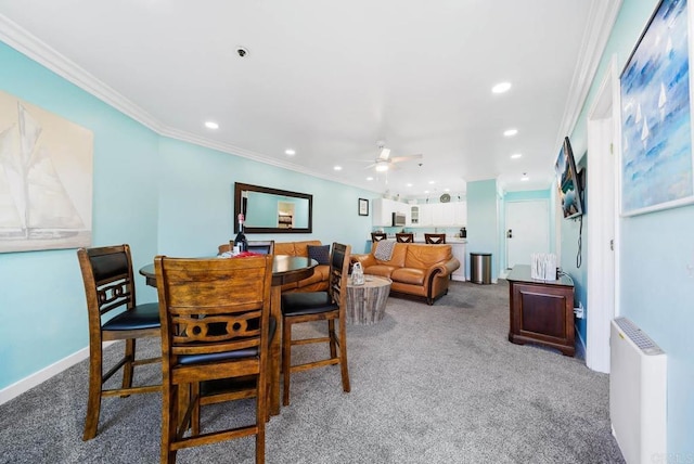 dining room with ceiling fan, ornamental molding, carpet, and radiator heating unit