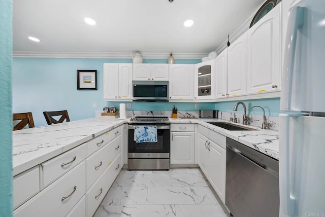 kitchen featuring white cabinetry, stainless steel appliances, and sink