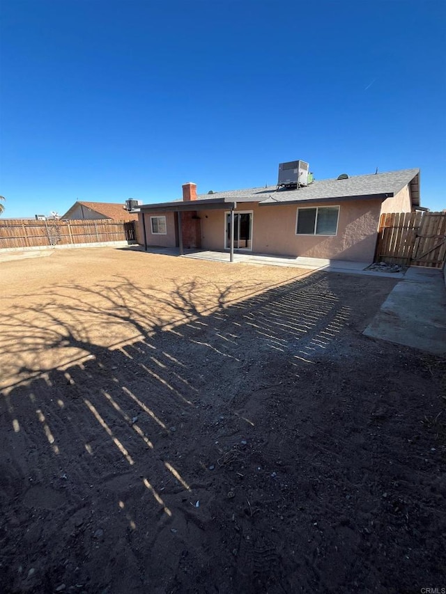 back of house featuring a patio, a fenced backyard, and stucco siding