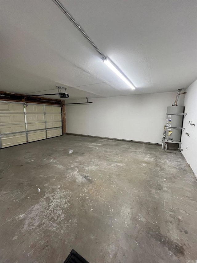 garage with strapped water heater and a garage door opener