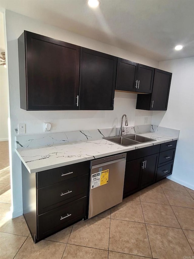 kitchen with light tile patterned floors, recessed lighting, a sink, dark cabinetry, and dishwasher