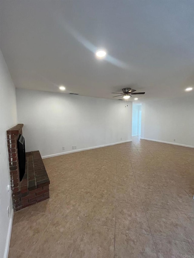 unfurnished living room with ceiling fan, recessed lighting, a fireplace, and baseboards