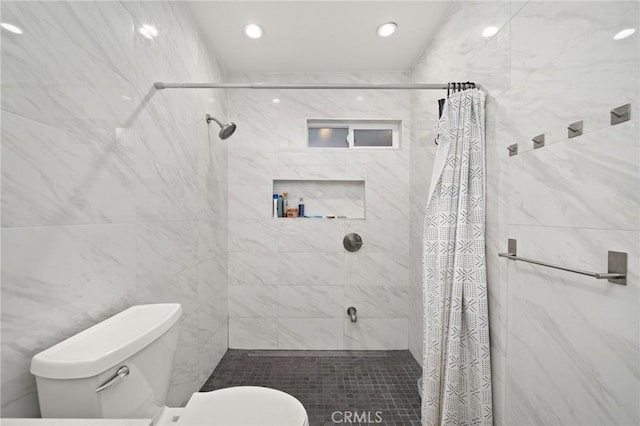 bathroom featuring toilet and walk in shower