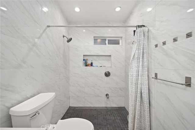 bathroom with recessed lighting, toilet, and a shower stall