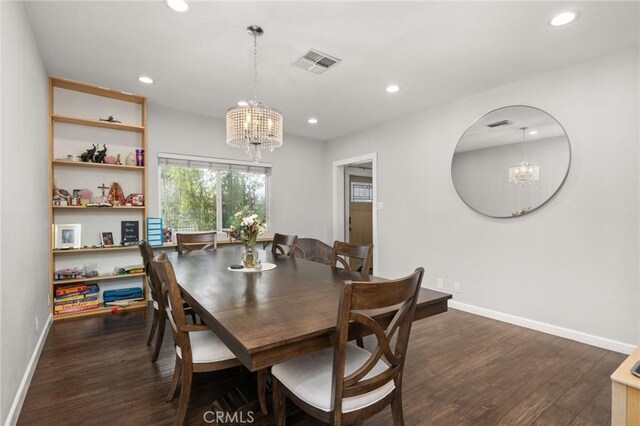 dining room featuring dark hardwood / wood-style flooring and a chandelier